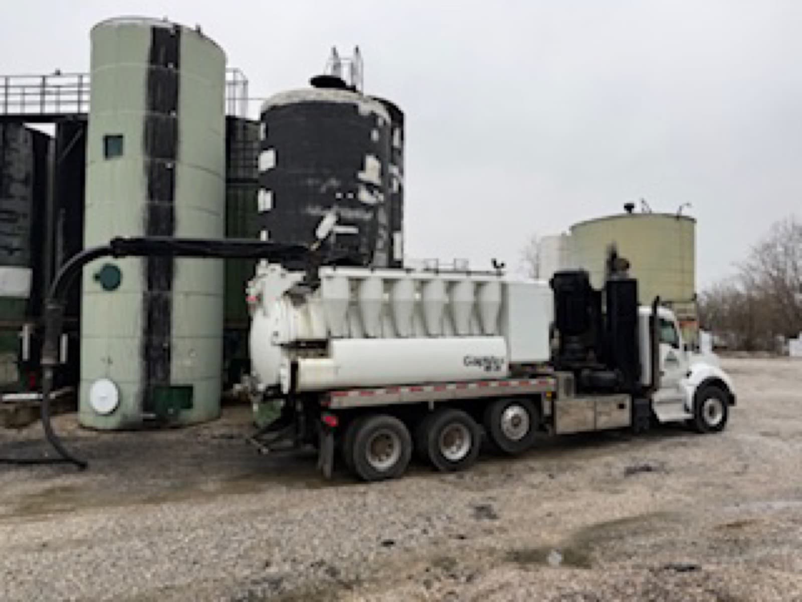 Ledgerock branded vac truck at industrial facility at night